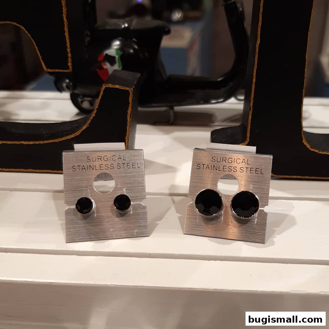 Two displays of surgical stainless steel earrings with black stones.