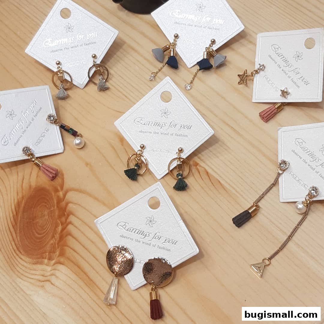 A collection of stylish earrings displayed on a wooden surface.