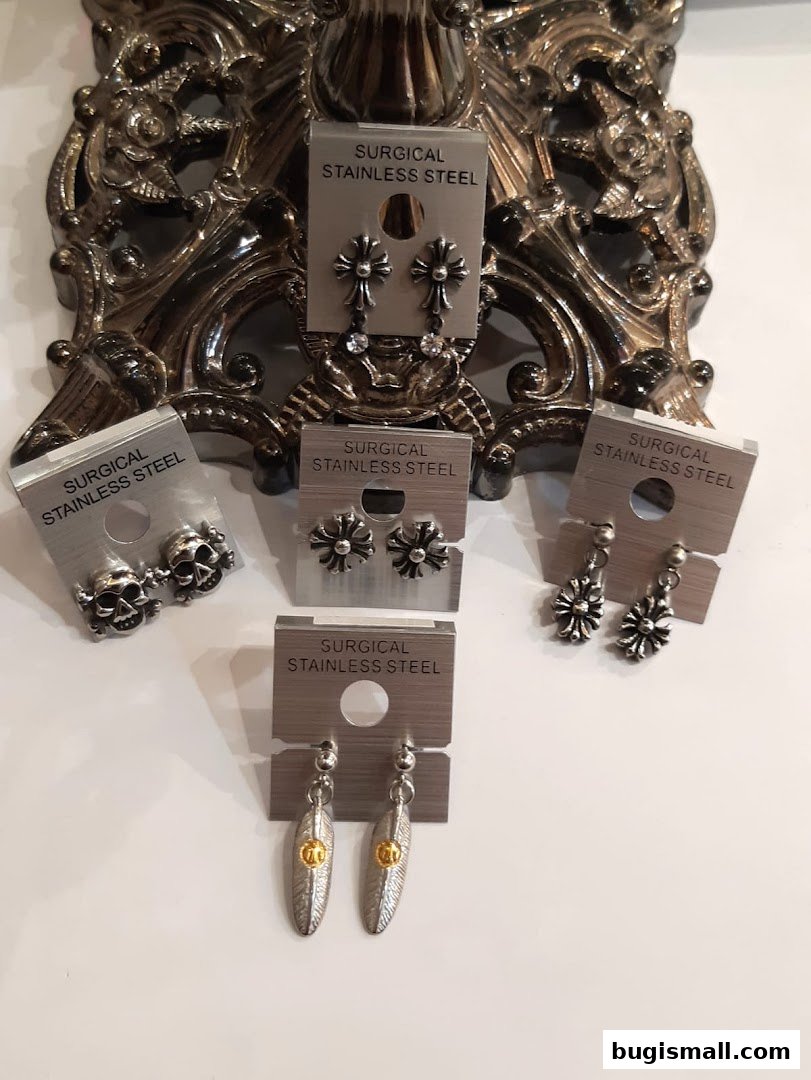 A display of various surgical stainless steel earrings with unique designs.