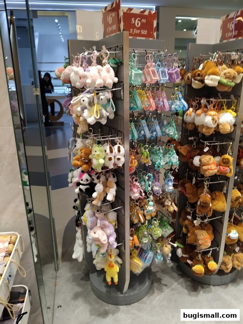A display of various cute plush keychains and charms in a retail store.