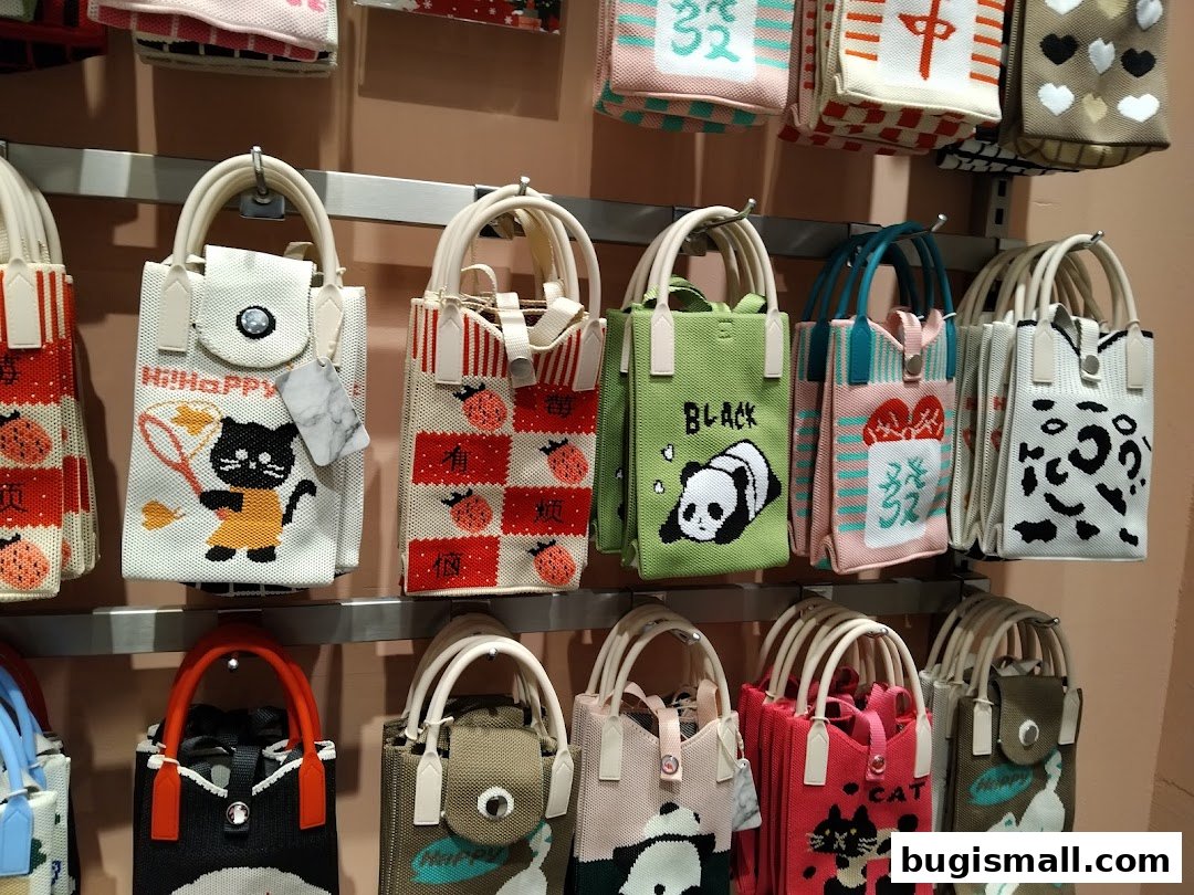 A display of various knitted tote bags with cute animal and graphic designs.