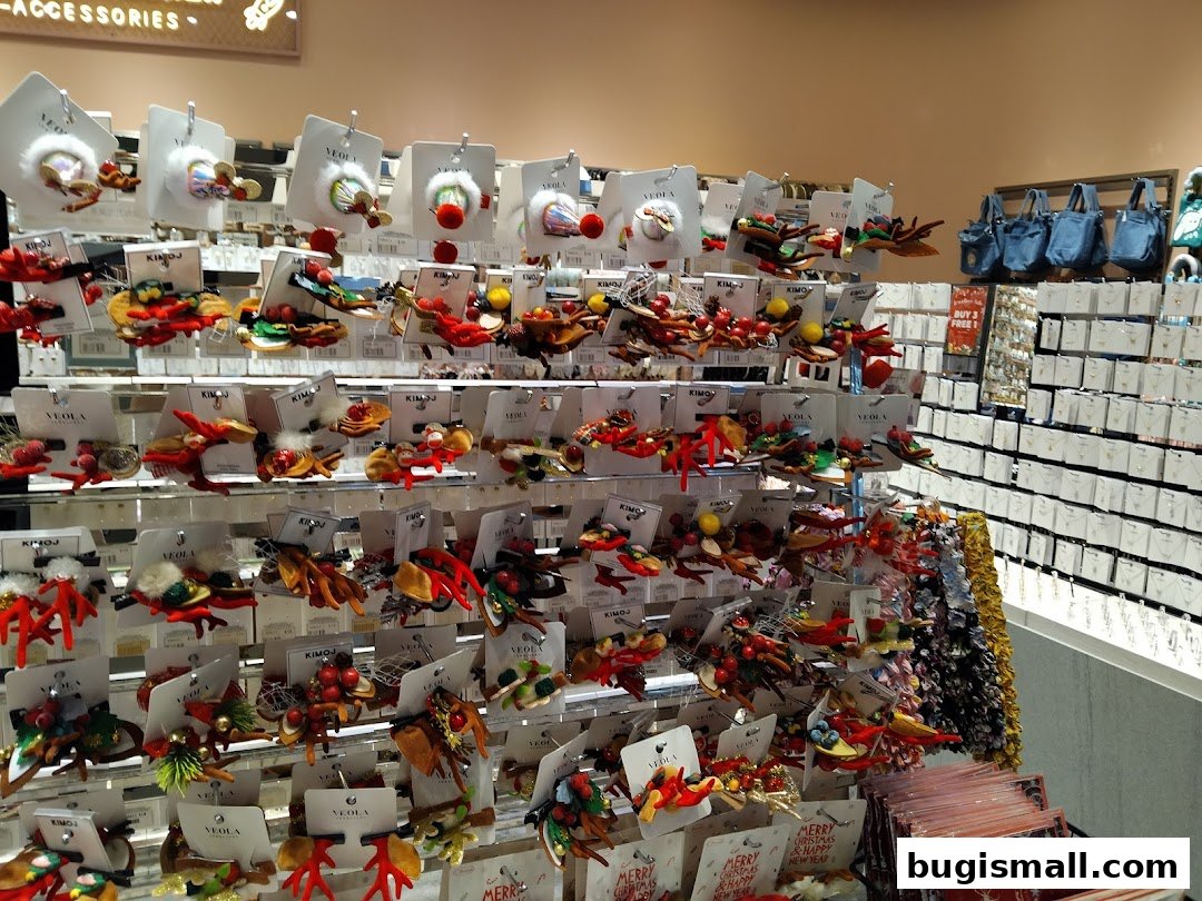 A display of festive hair accessories and bags in a retail store.