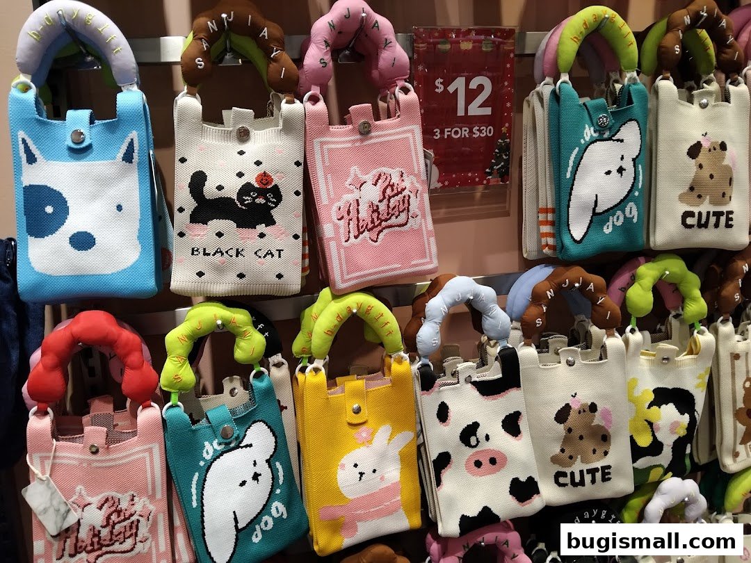 A display of colorful knitted bags with cute animal designs and text.