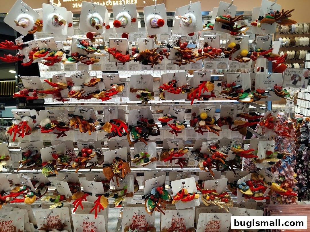 A display of festive hair accessories, featuring Christmas-themed designs like reindeer and berries.