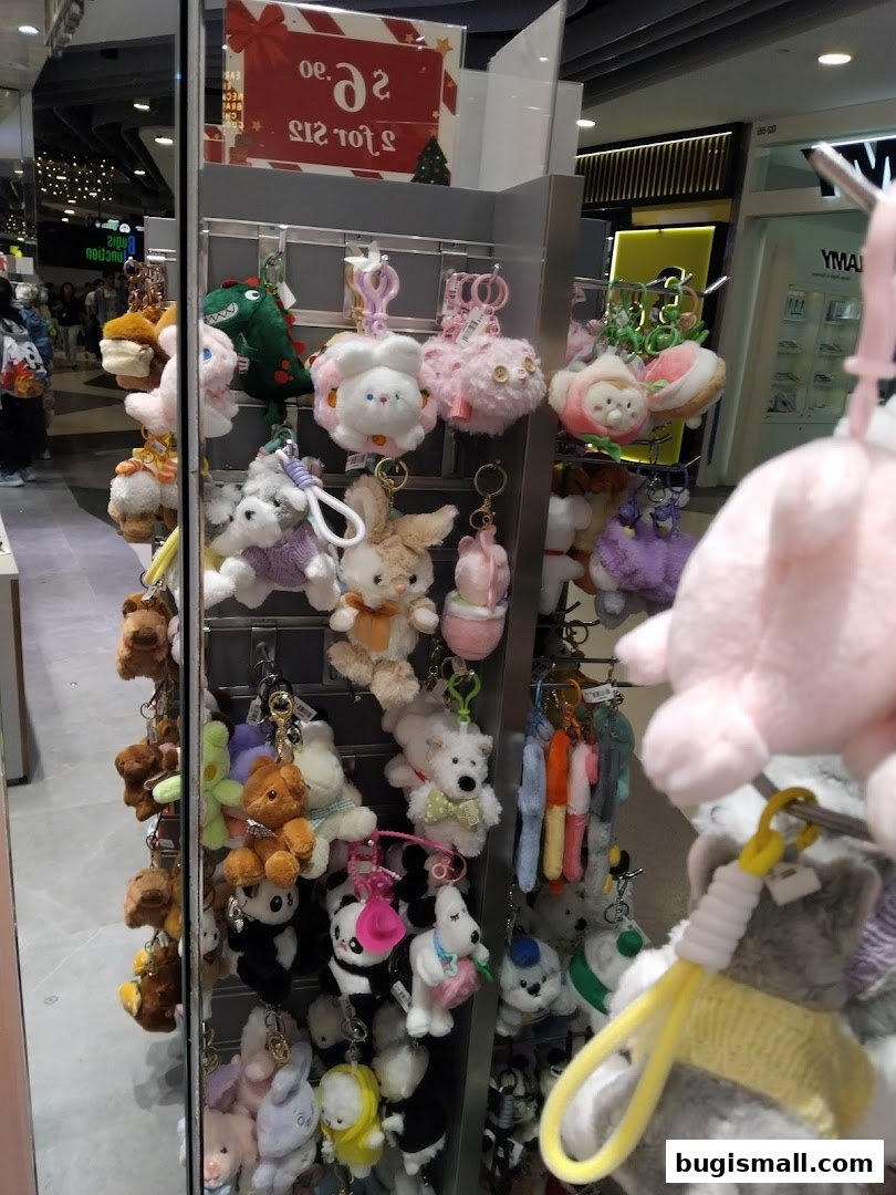 A display of cute plush keychains featuring animals and cartoon characters.