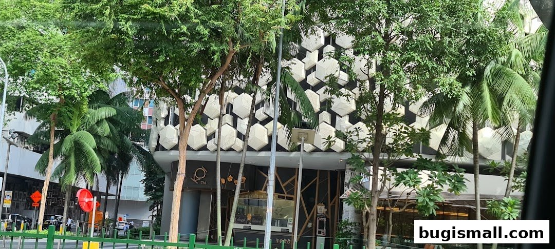 The KOI Thé Bugis shop front with its distinctive hexagonal facade and lush greenery.