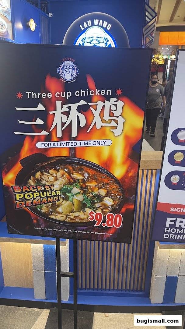 A promotional sign for Lau Wang Claypot Delights featuring their Three Cup Chicken dish.