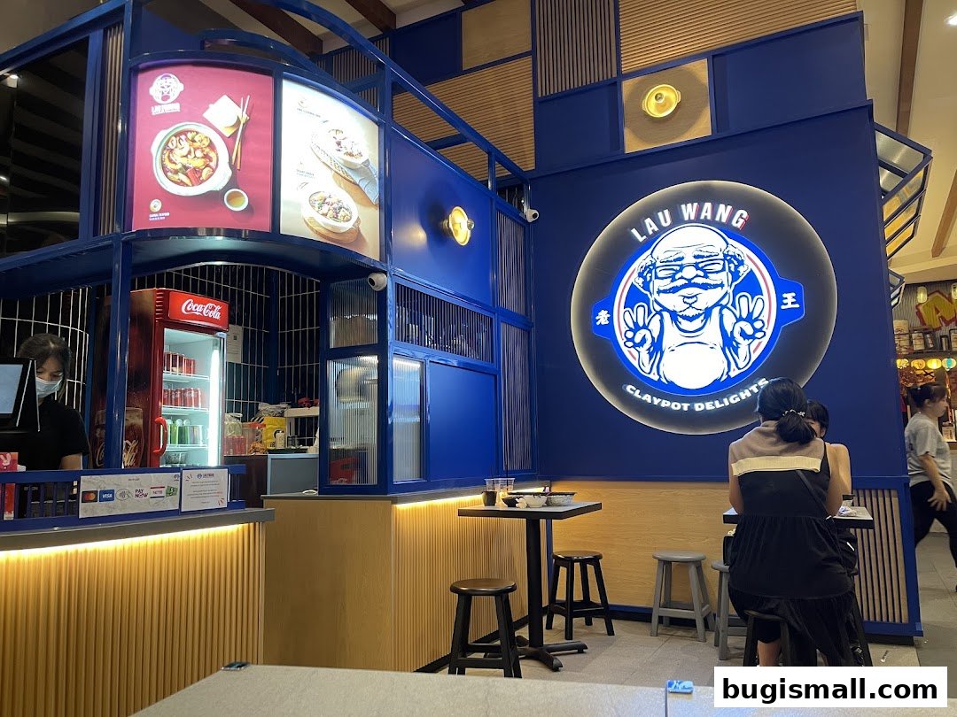Interior of Lau Wang Claypot Delights with seating, counter, and prominent branding.
