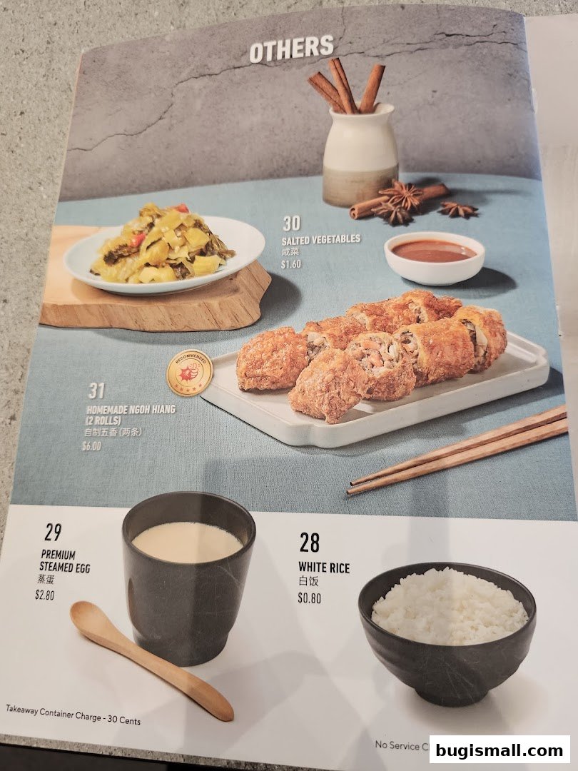 A menu page showcasing various dishes including salted vegetables, homemade ngoh hiang, premium steamed egg, and white rice.