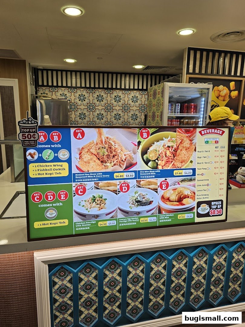 A digital menu board displaying various set meals and beverages offered at Lau Wang Claypot Delights.