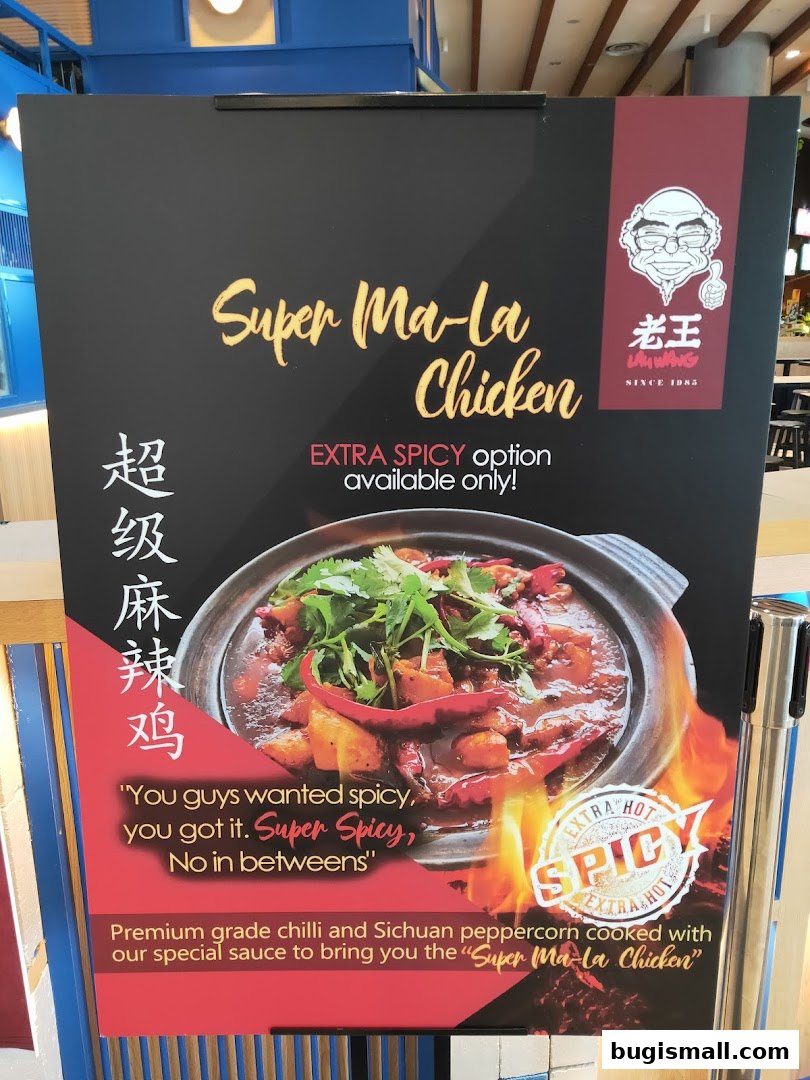 A promotional sign for Lau Wang's Super Ma-la Chicken, highlighting its extra spicy nature.