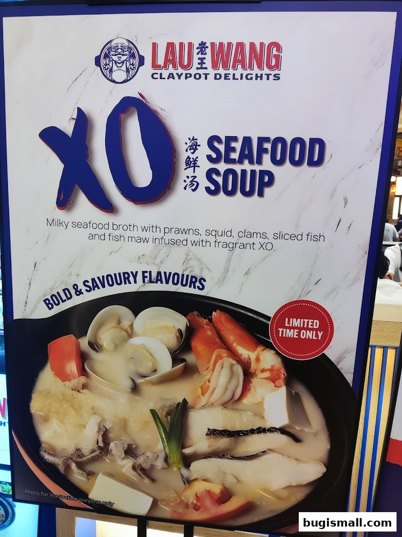A sign advertising Lau Wang Claypot Delights' XO Seafood Soup, featuring a rich broth with seafood.