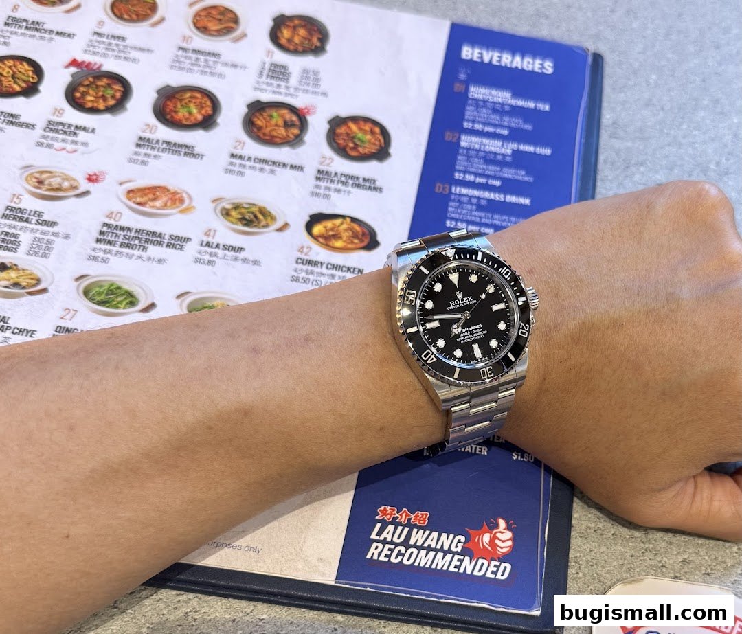 A person's wrist with a Rolex watch is shown over a menu from Lau Wang Claypot Delights.