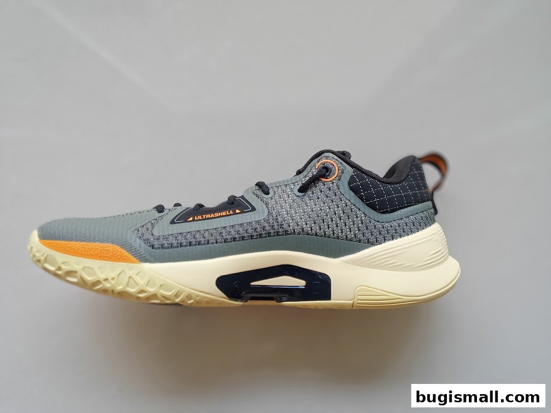 A side view of a grey and cream Li-Ning athletic shoe with orange accents.