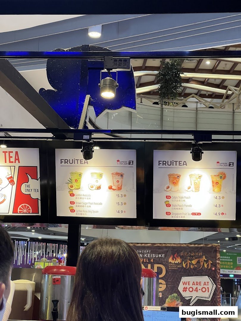 A menu board displaying various fruit tea options with prices and images.