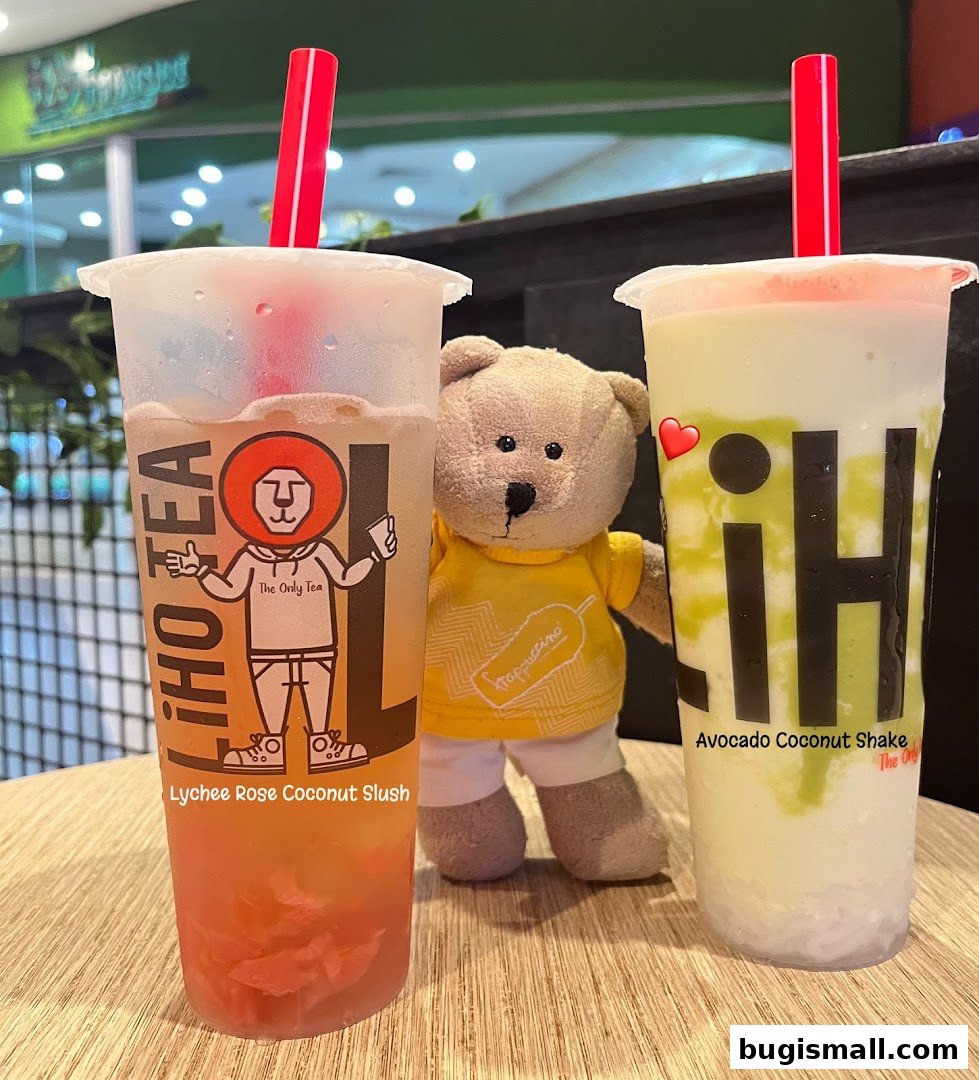 Two LiHO TEA drinks, Lychee Rose Coconut Slush and Avocado Coconut Shake, with a teddy bear.
