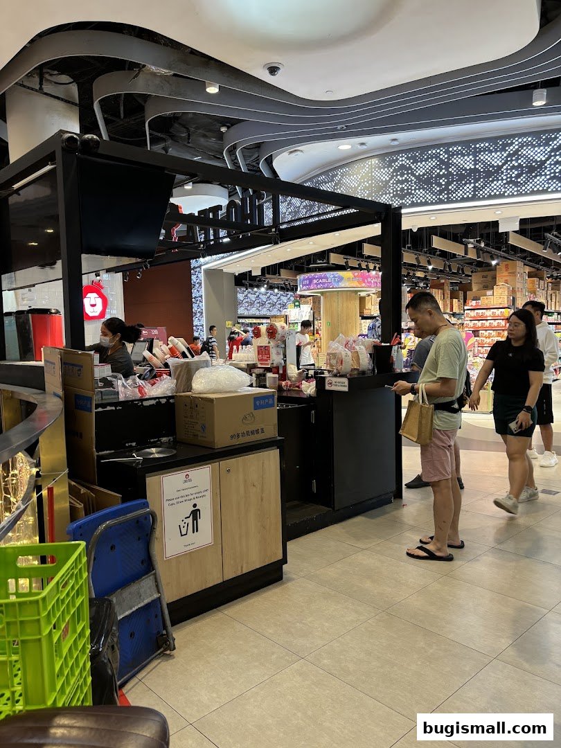 Customers queue at a LiHO TEA stall in a shopping mall.