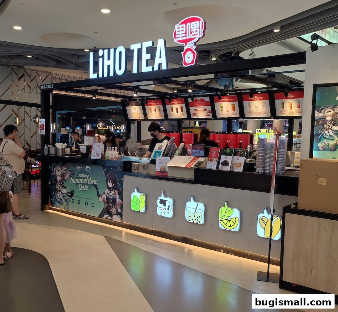 A LiHO TEA shop counter with staff serving customers and menu displays.