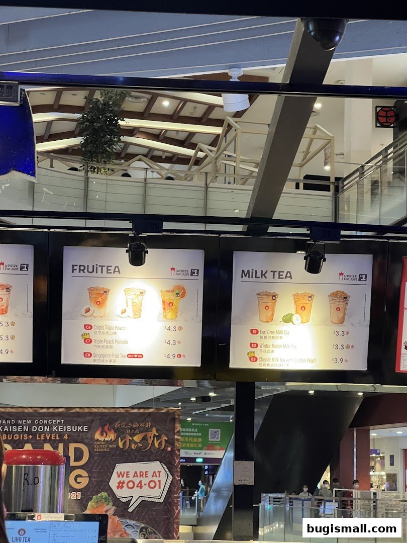 A menu board displaying fruit and milk tea options with prices.