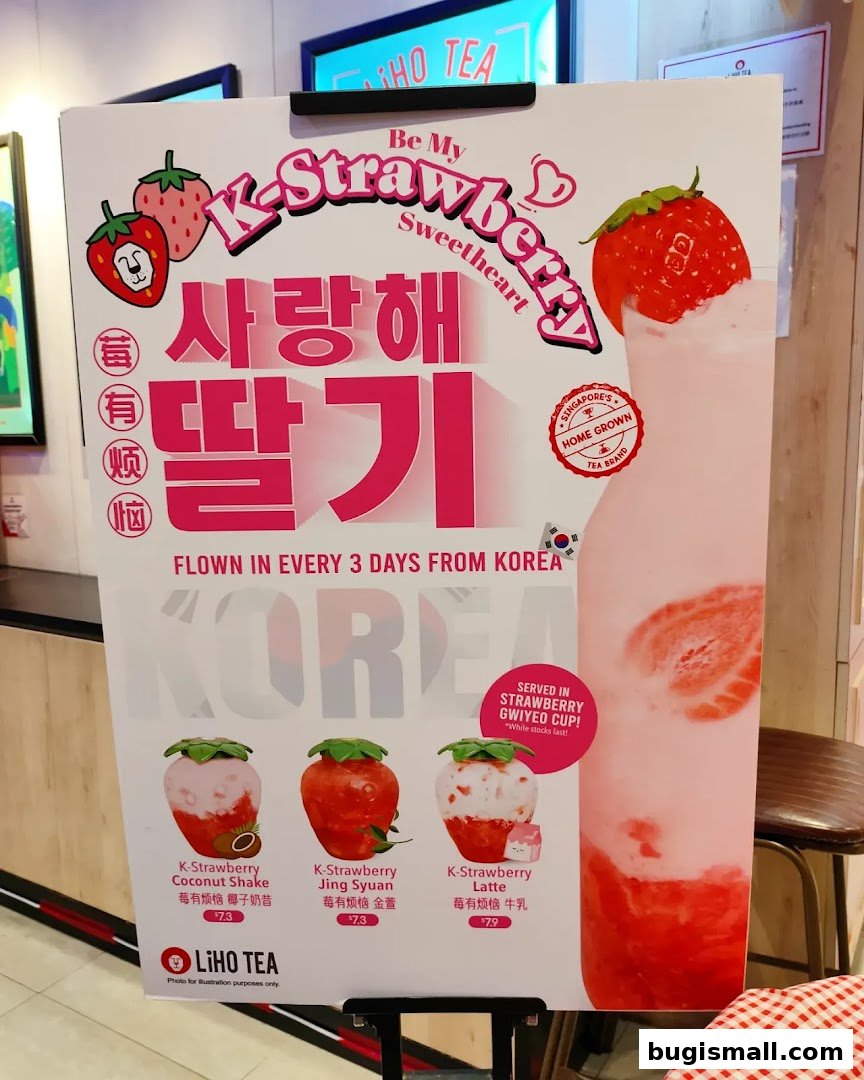 A promotional sign for LiHO TEA's K-Strawberry drinks, featuring Korean text and product images.