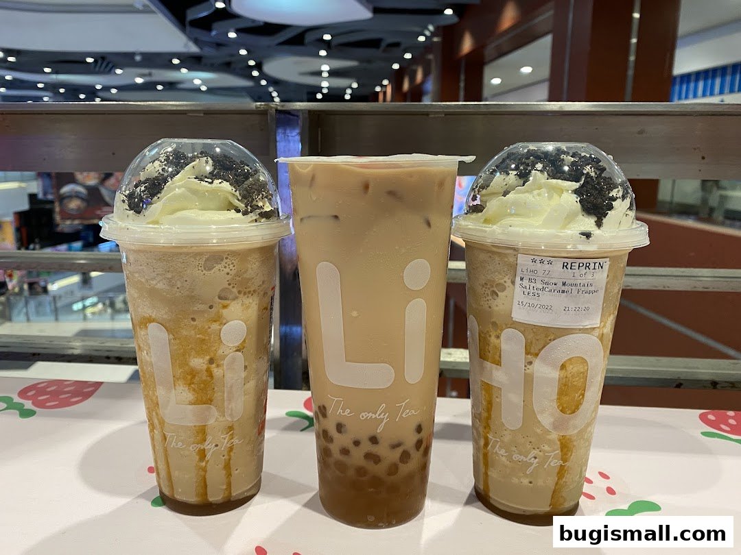 Three bubble tea drinks from LiHO TEA, two with whipped cream and cookie crumbles.