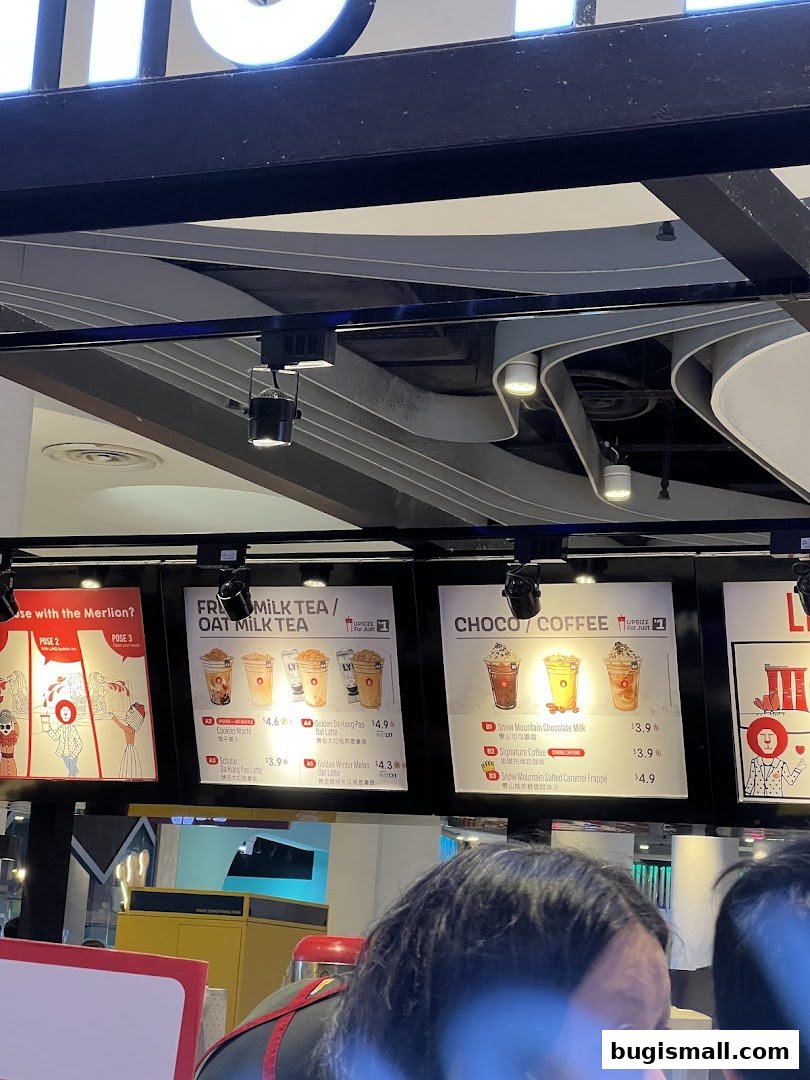 A menu board displaying various milk teas, coffees, and drinks with prices.