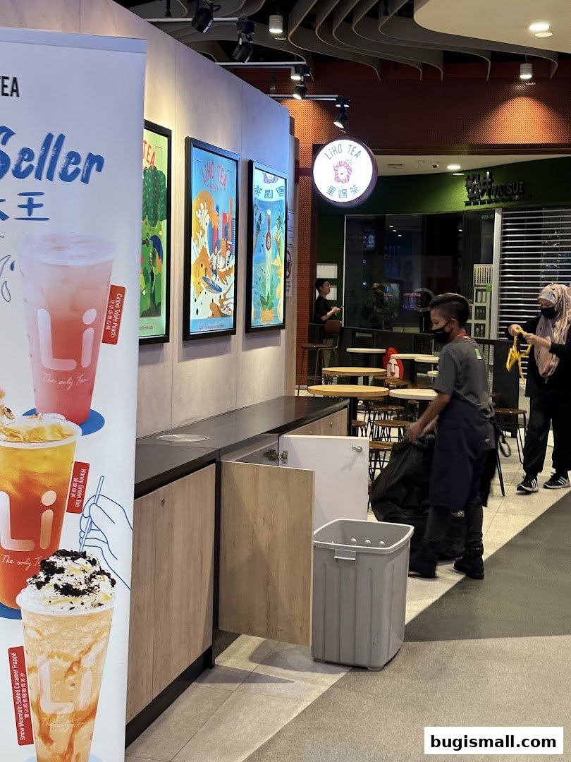 LiHO TEA shop with promotional posters and staff working.