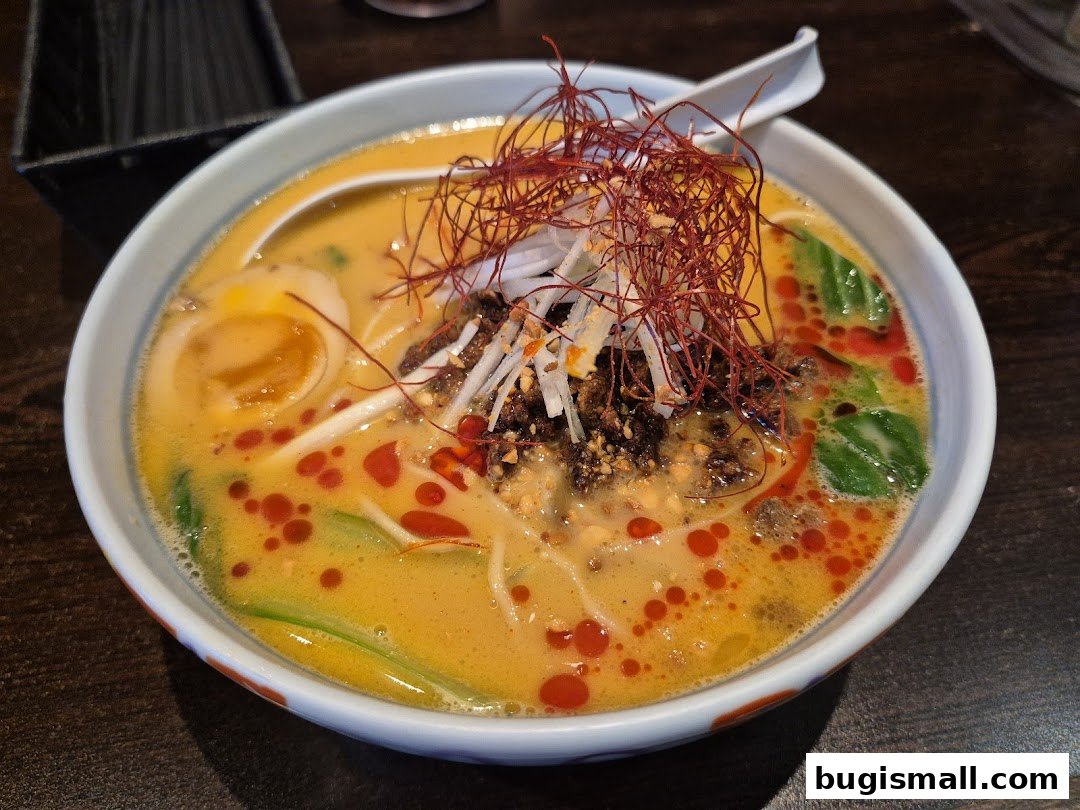 A close-up shot of a steaming bowl of ramen with rich broth, noodles, and toppings.