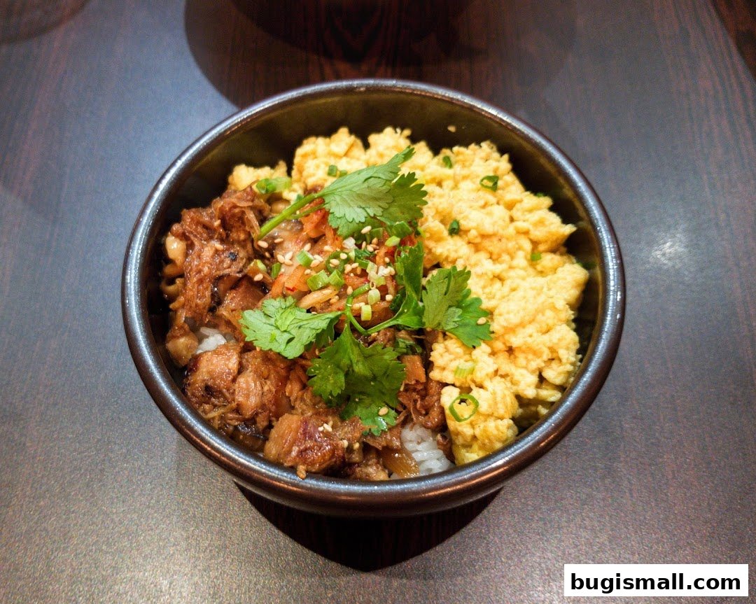A close-up shot of a delicious ramen dish with scrambled eggs and meat.