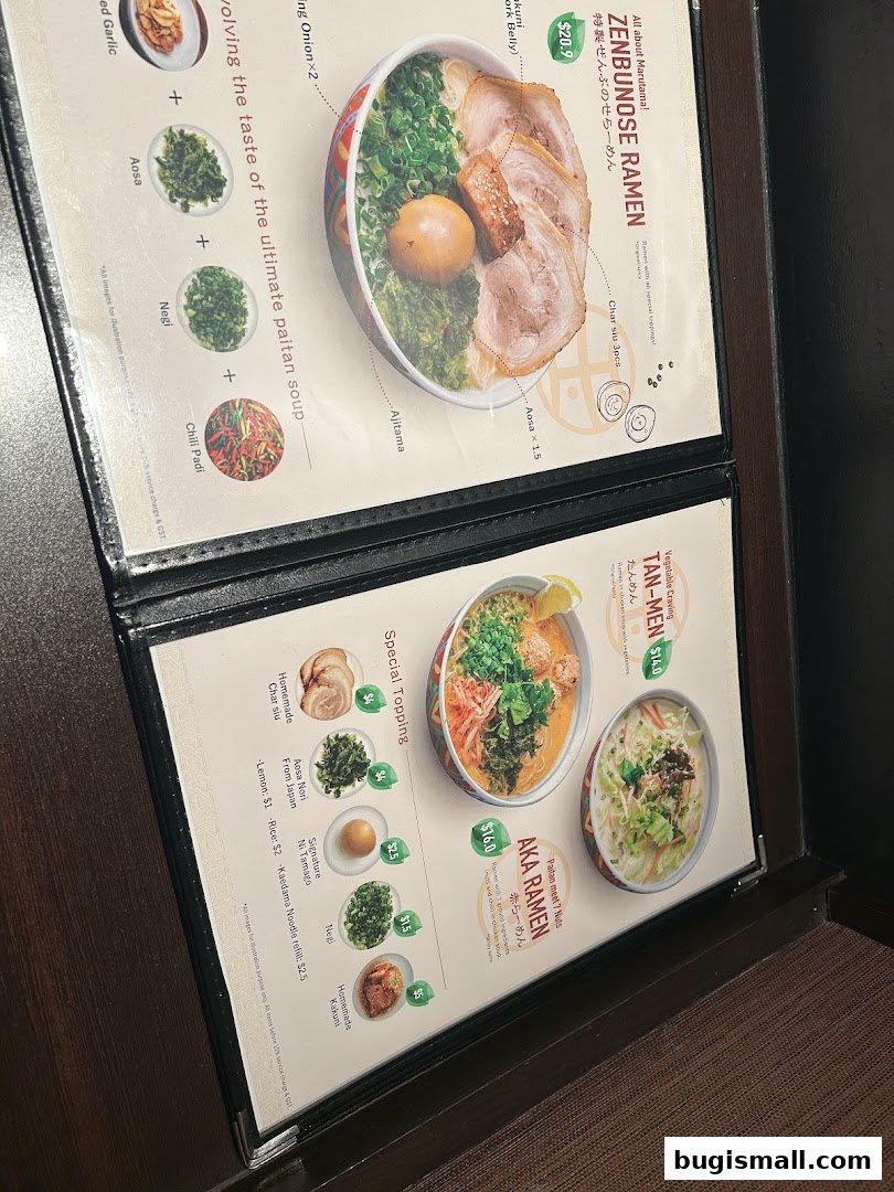 A menu from Marutama Ramen Bugis featuring various ramen dishes and toppings.