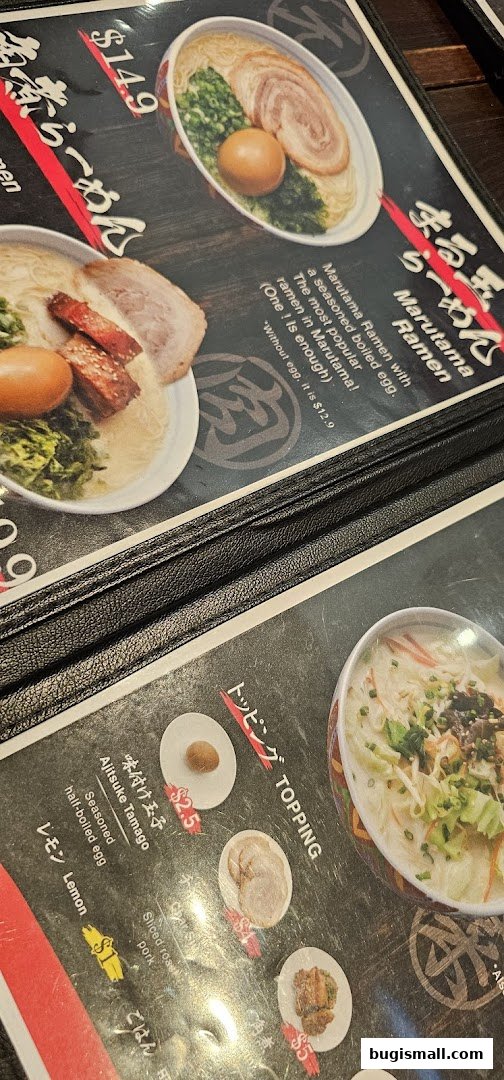 A menu from Marutama Ramen featuring popular ramen dishes and toppings.