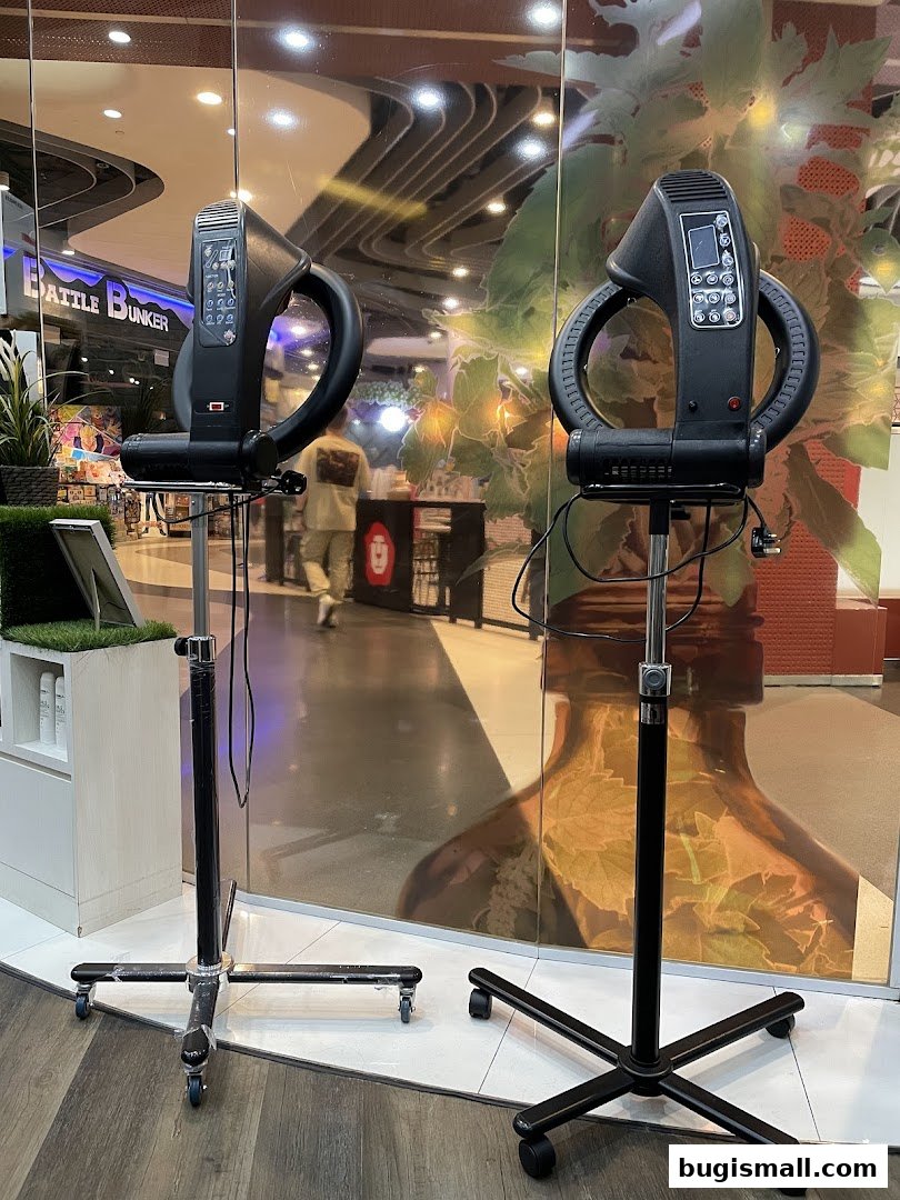 Two professional hair steamers are displayed in a salon setting, with reflections of the mall visible.