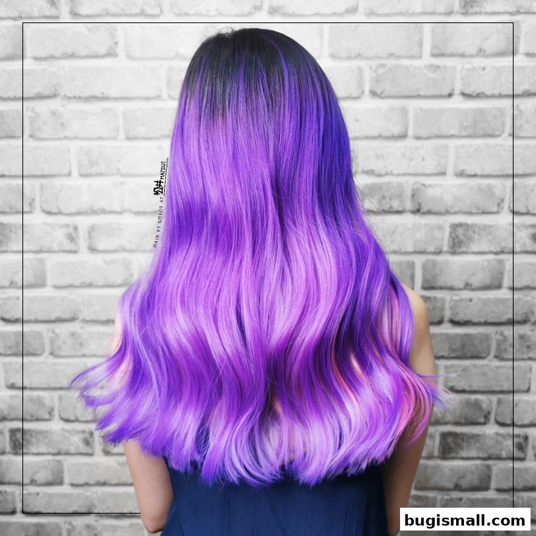 A person with long, wavy hair dyed in vibrant shades of purple and pink.