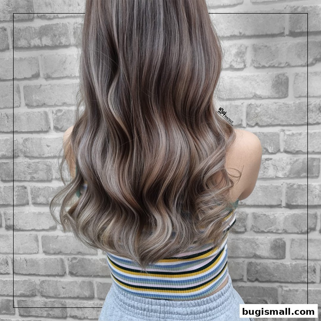 A person's back showcasing beautifully styled, wavy hair with highlights.