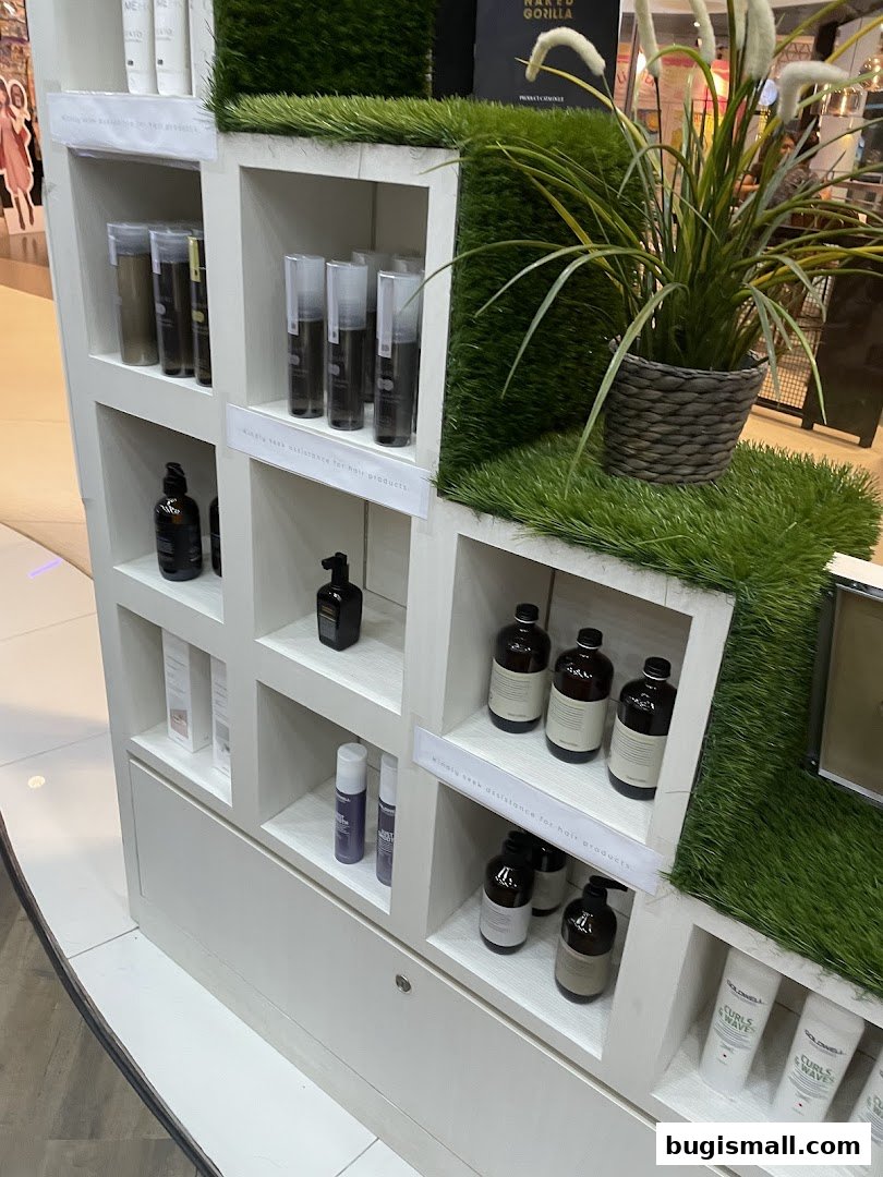 A display shelf showcasing various hair products with artificial grass accents.