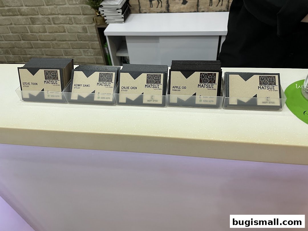 Business cards for stylists at Matsui Hair Studio displayed on a counter.
