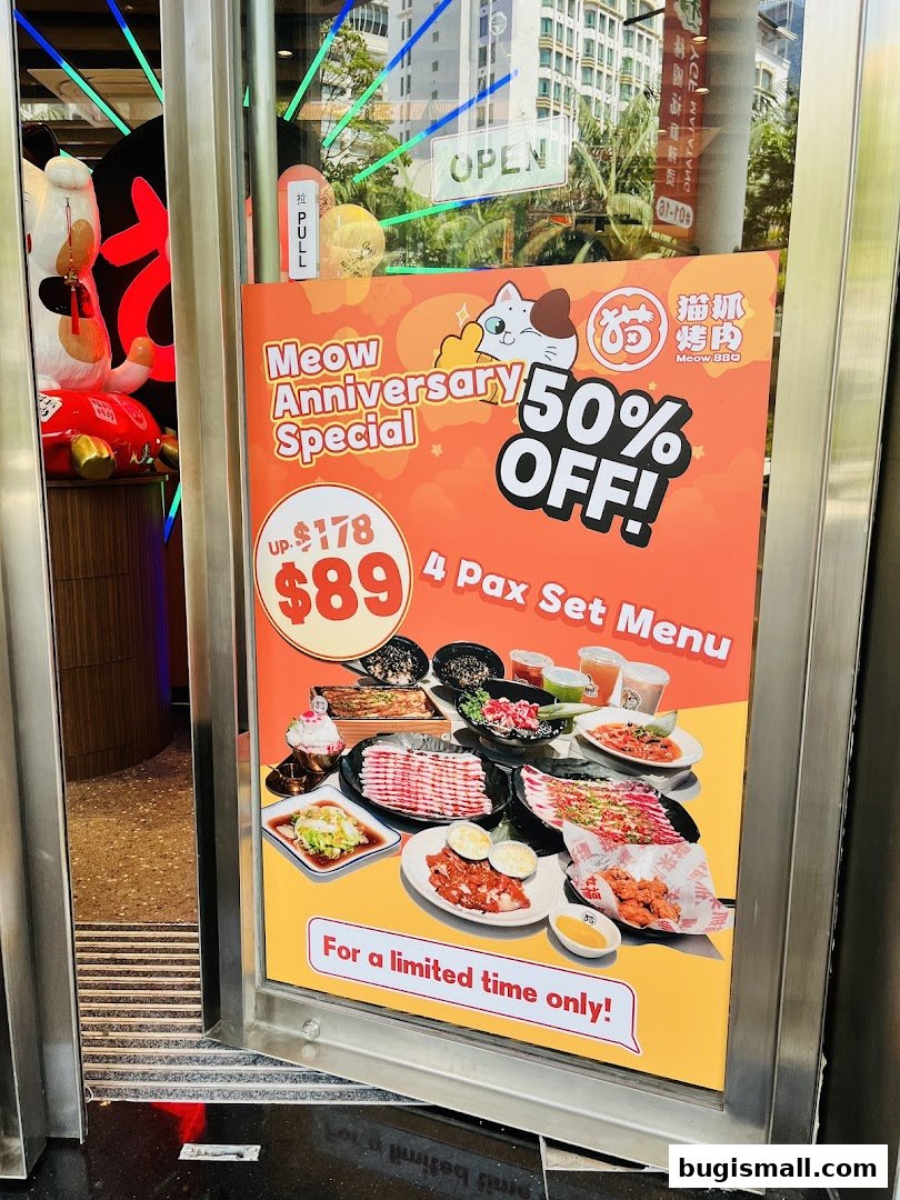 A shop front display advertises a 50% off anniversary special for a 4-person set menu.