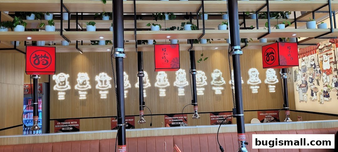 Interior of a barbecue restaurant with zodiac signs and hanging grills.