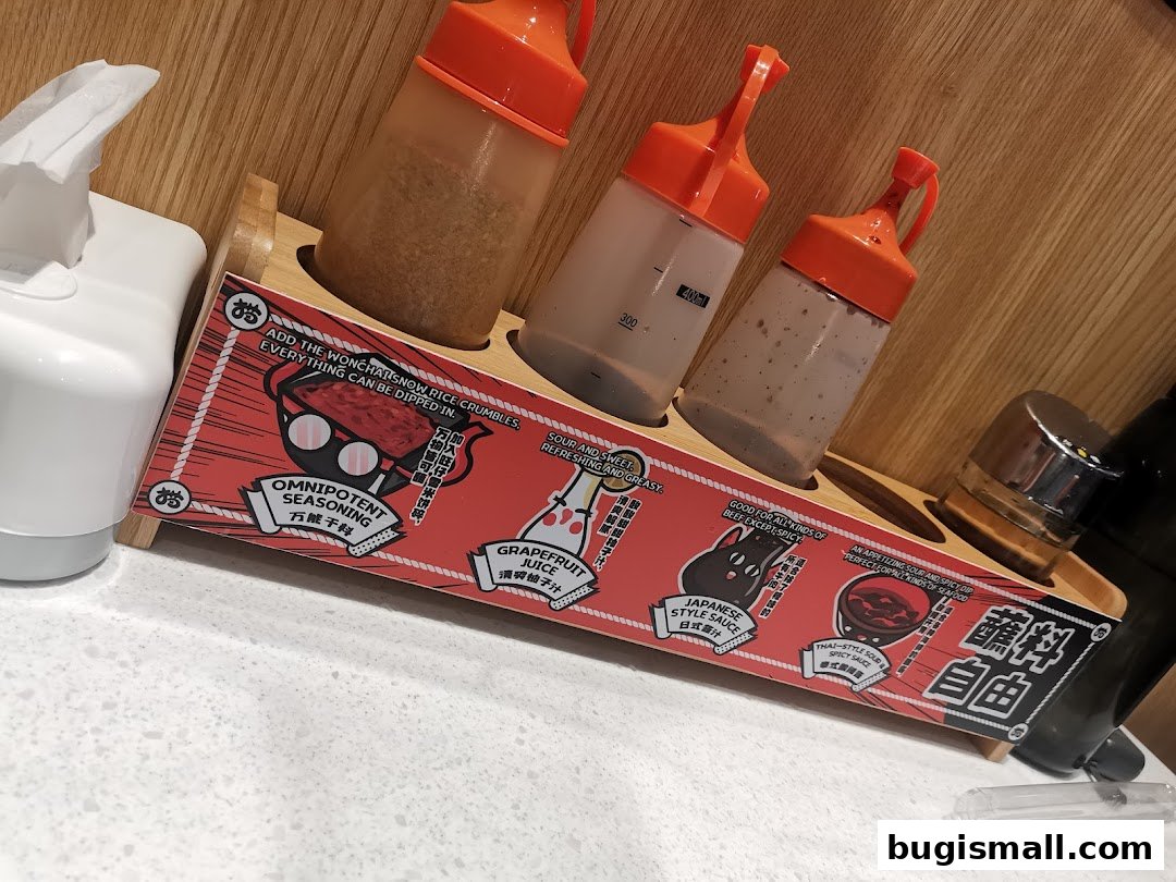 A selection of sauces and seasonings in bottles and jars on a wooden rack.