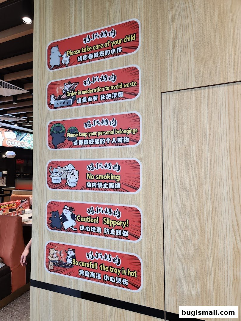 A wall with several safety and courtesy signs for a barbecue restaurant.