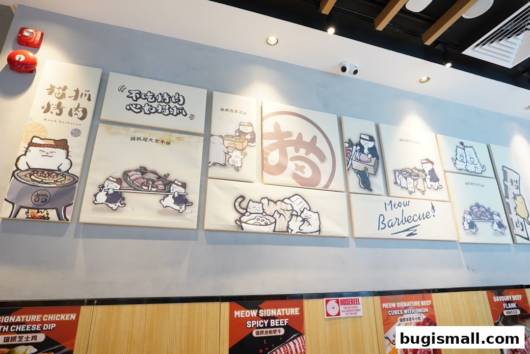 Wall art featuring cartoon cats and barbecue themes at Meow Barbecue.