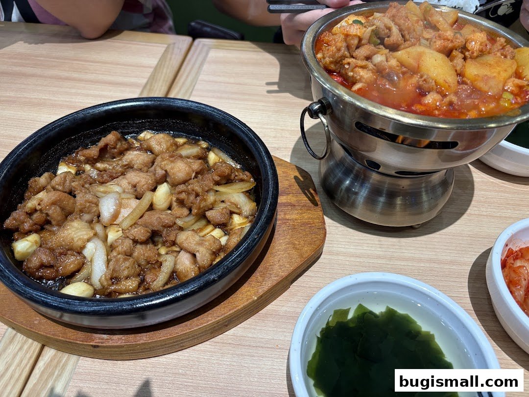 Two Korean dishes, one with meat and onions, the other a stew with potatoes.