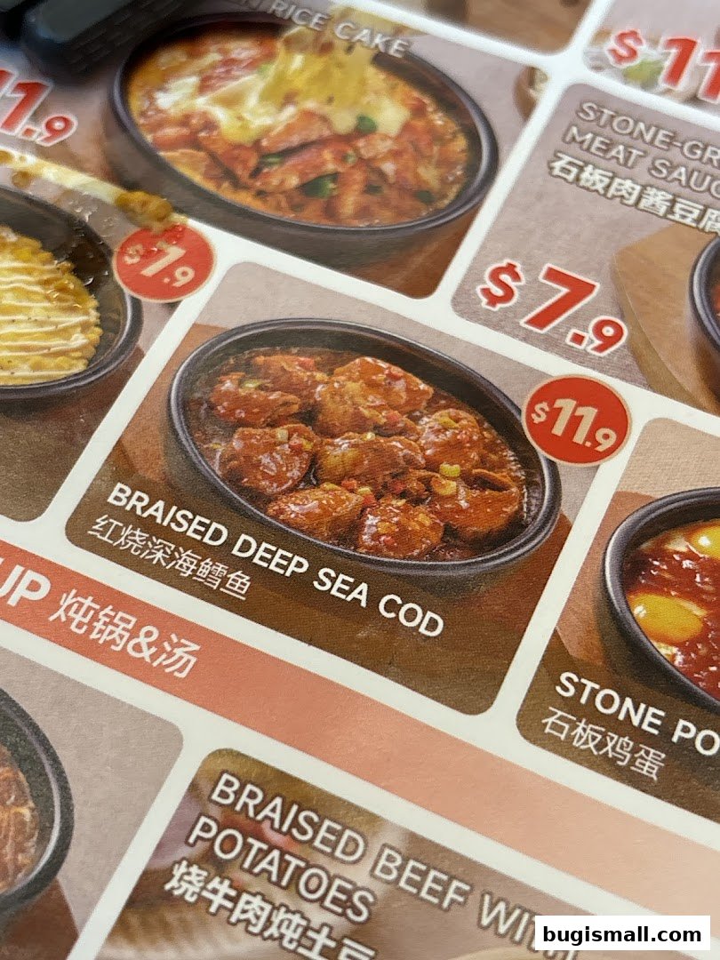 A close-up of a menu featuring various Korean dishes with prices.