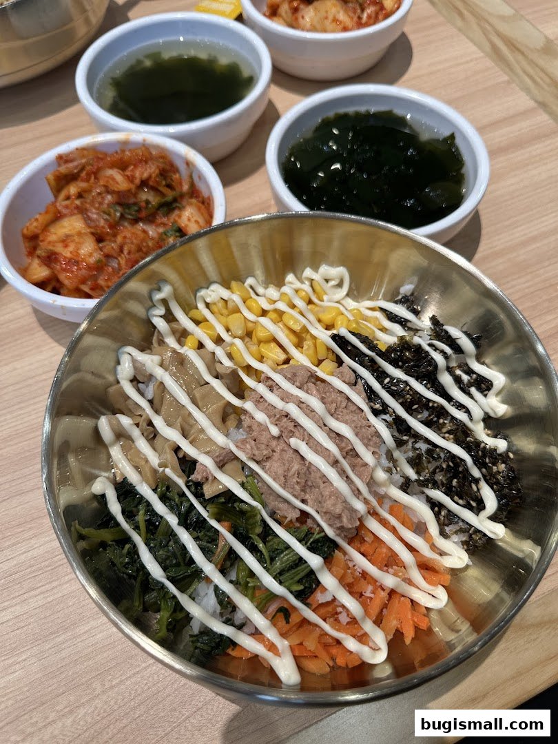 A close-up of a bibimbap dish with various toppings and side dishes.