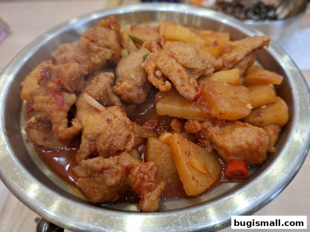 A close-up of a delicious Korean dish with tender meat and vegetables in a savory sauce.