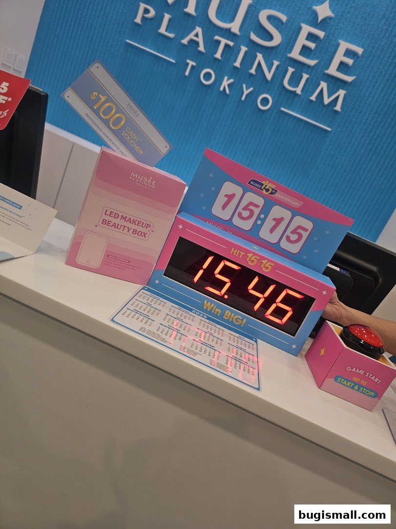 A counter display at Musee Platinum Tokyo with promotional items and a digital timer.