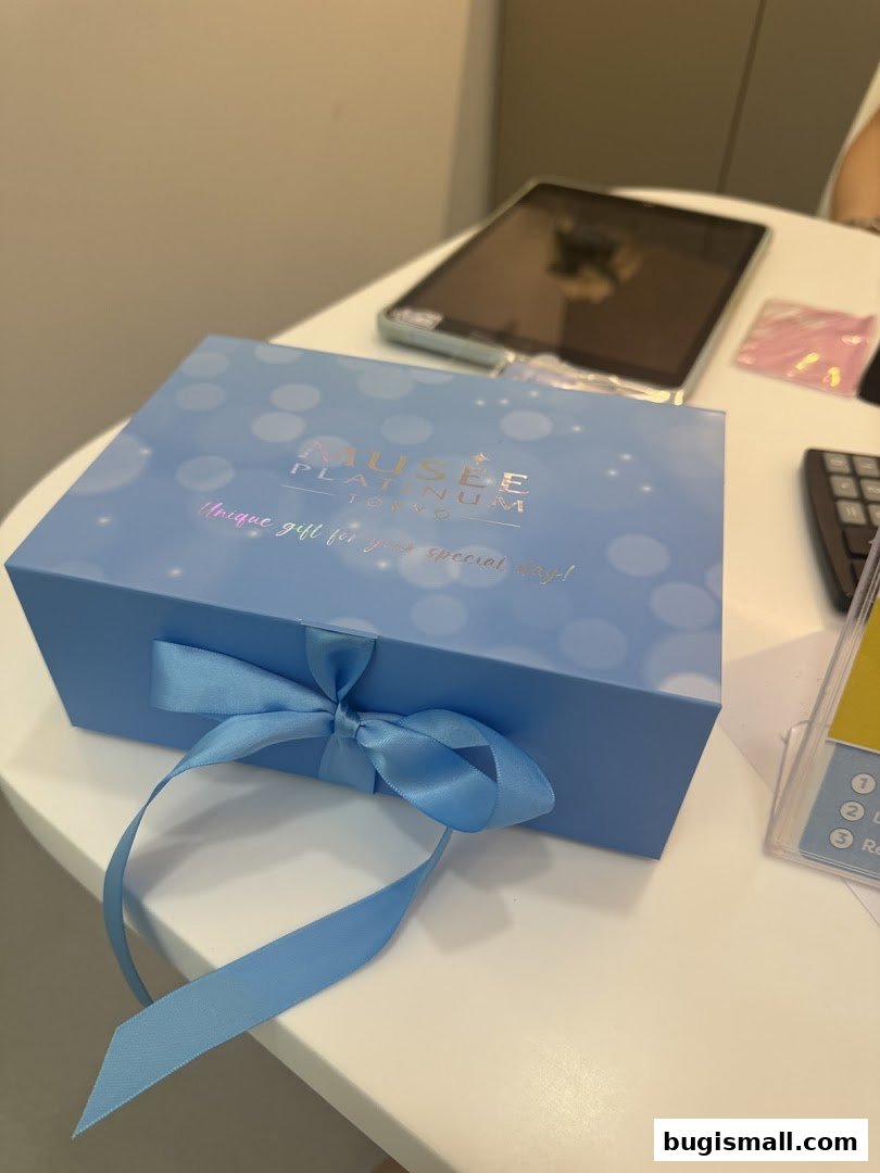 A light blue gift box with a ribbon from Musee Platinum Tokyo.