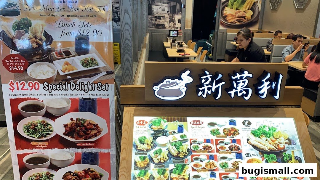 A restaurant interior featuring a menu board and dining tables with customers.
