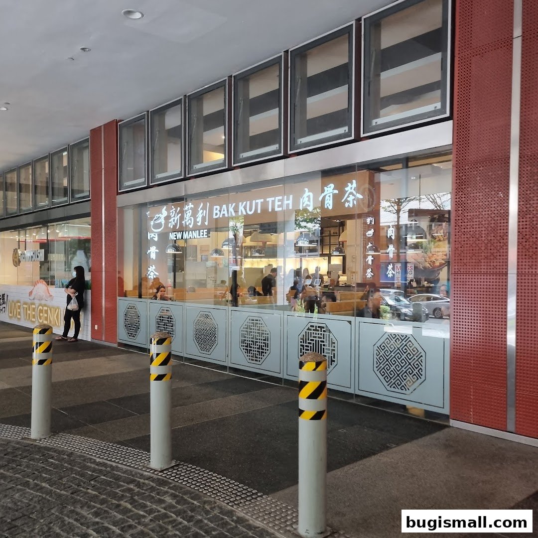 The exterior of New Manlee Bak Kut Teh, a restaurant with large glass windows and signage.