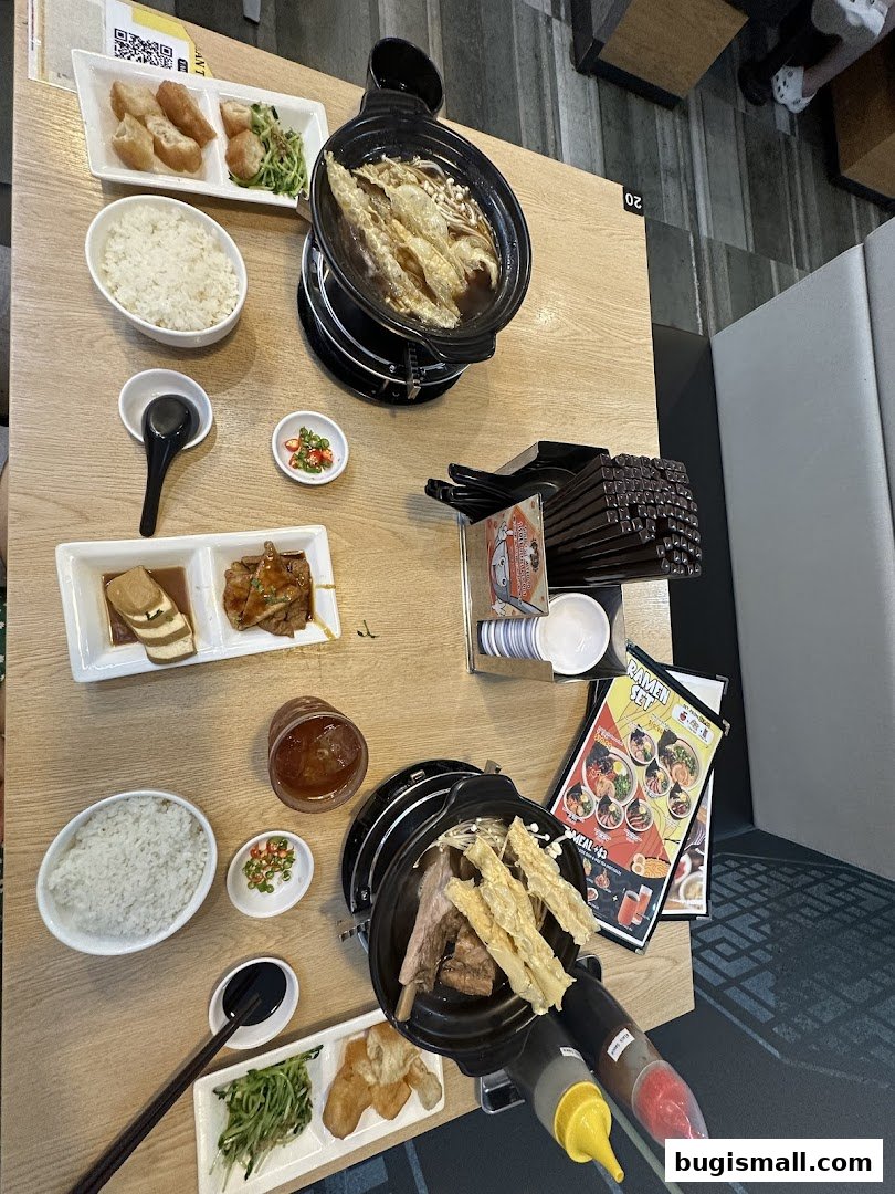 A table laden with delicious Bak Kut Teh, rice, and side dishes, ready to be enjoyed.
